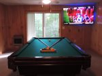 Pool Table in the Game Room with a 65-iinch Flat Screen TV